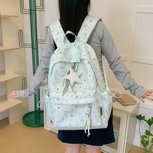 Detail shot of Korean style mint green star print backpack featuring a star shaped pendant