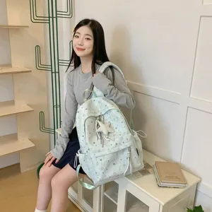 Detailed view of the light green Korean style star pattern backpack with a plush star charm
