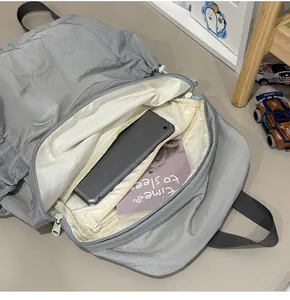 Detail showing interior compartment of gray minimalist lightweight backpack with tablet