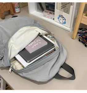 Internal view of minimalist grey backpack showing capacity for a tablet and book