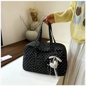 Polka dot Boston bag close-up detail showing the heart charm and pattern decoration