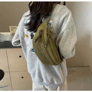Olive green sports chest bag worn as a crossbody waist bag for women in lifestyle