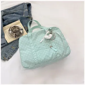 Elegant mint green polka dot Boston bag with heart charm for women's daily commute