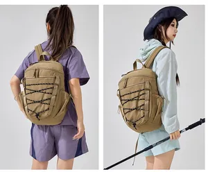 Macro detail of khaki hiking backpack with bungee cords worn by models outdoors