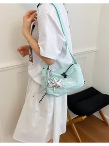 Detailed side view of a mint green Korean style crossbody bag with starfish charm