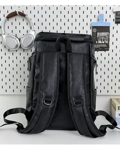 Back view of black vintage leather backpack with adjustable padded shoulder straps.