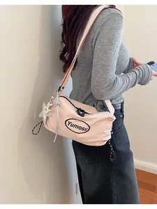 Stylish light pink lightweight crossbody bag featuring crinkled texture and a cute star charm