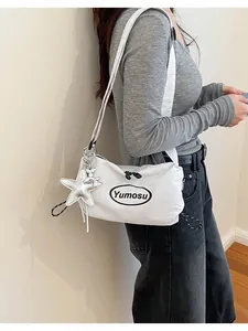 Detailed side view of a minimalist white Korean-style lightweight crossbody bag on model