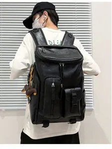 Rear view of a model wearing a large black retro PU leather business backpack for travel