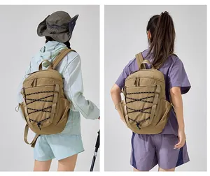 Back view of a khaki outdoor sports backpack featuring a unique black bungee cord design.