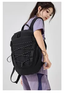 Detail shot of a black large capacity outdoor sports backpack with bungee cord design