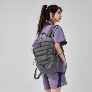 Large capacity grey outdoor sports backpack with functional bungee design for hiking