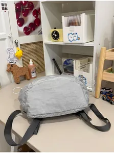 Detail bottom view of a minimalist grey lightweight nylon backpack for commuting.