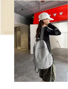 Lightweight grey minimalist backpack for travel and daily commute worn by model