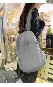 Lightweight minimalist grey nylon backpack for student travel and daily commuting.