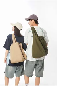 Couple carrying large nylon drawstring tote bags in khaki and olive green for fitness.