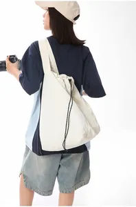 Model wearing the off-white minimalist large capacity nylon drawstring tote bag