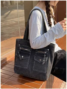 Outdoor lifestyle shot of a large multi-pocket washed denim tote bag for women