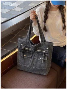 Large charcoal vintage denim tote bag with front pockets styled with a casual outfit