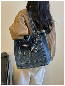 Back view of a large capacity blue denim tote bag with multiple pocket details