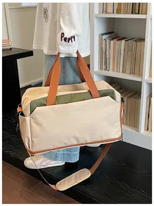 Vue lifestyle d'un grand sac de sport avec séparation sec-humide tenu par un mannequin.