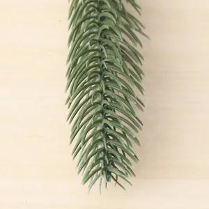 Close-up detail of realistic green artificial pine branch for DIY home decor