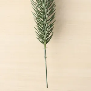 Detailed macro view of a lifelike artificial green pine needle branch for DIY home decor