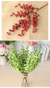 Detailed macro view of artificial red and green berry branches for home decoration