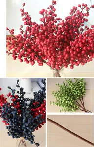 Detailed view of colorful artificial berry branches showing red blue green colors and textured stem