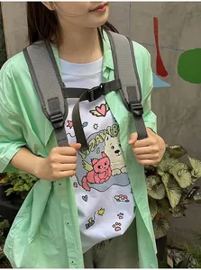 Detailed view of the adjustable grey shoulder straps and chest buckle of the backpack.