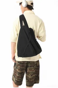 Male model wearing a large black nylon drawstring shoulder bag for sports and fitness