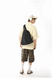 Detailed rear view of a male model wearing the casual black nylon single shoulder bag.