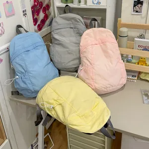 Lightweight pastel backpacks in blue pink yellow and grey for school or travel