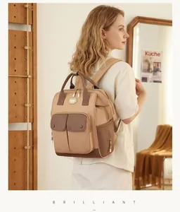 Back view of a stylish large capacity beige and brown multi-functional diaper backpack.