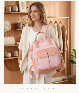 Stylish pink large capacity diaper bag backpack worn by model in lifestyle setting