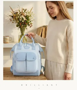 Stylish light blue large capacity multi-functional mommy backpack shown in home setting
