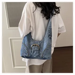 Back view of a model wearing a heavy craft denim motorcycle bag with silver rivets