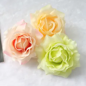 Close-up view of three soft pastel artificial silk rose heads for wedding decoration