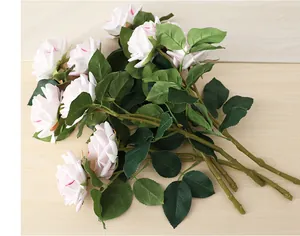 Detailed view of artificial pink and white rose bouquet on a light wood background