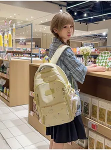 Vista detallada de una mochila escolar amarilla para niña con estampados de osos y estrellas.