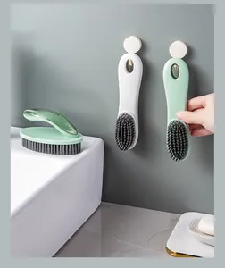 Detail view of wall-mounted soft-bristle cleaning brushes showing convenient storage hook
