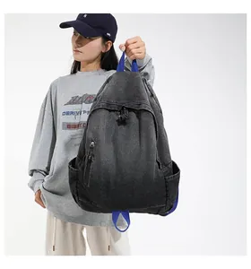 Female model carrying a large gradient washed denim backpack with vibrant blue straps