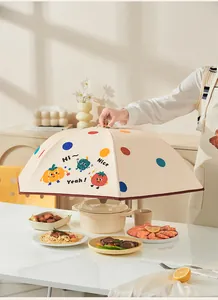 Foldable insulated food cover with cute cartoon patterns shown over dishes on table