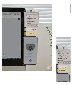 Transparent acrylic monitor memo board for office messages with integrated phone stand.