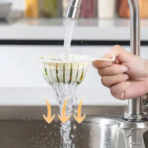 Effective white plastic kitchen sink strainer basket with handle under running faucet water