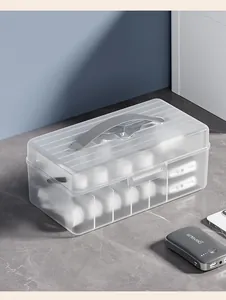 Detail view of a translucent cable organizer box with divided compartments for chargers
