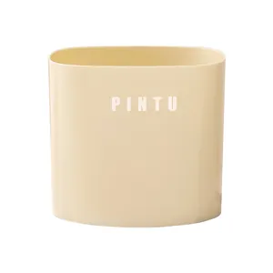 Minimalist cream oval desktop trash can with lidless design for home and office storage.