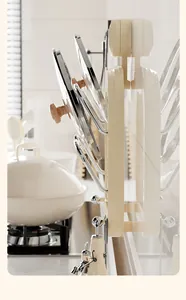 Side view of cream suction cup pot lid rack holding three lids in a kitchen setting