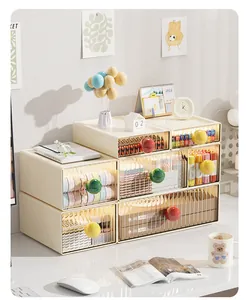 Desktop scene showing stackable cream storage drawers with colorful round knobs