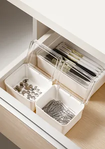 Compact white storage box with clear flip lid organizing stationery items inside an office drawer